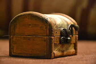 Vintage Wooden Treasure Chest With Metal Lock On Brown Fabric