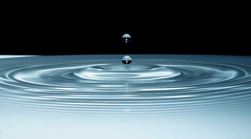 Water Droplet Splash Ripples On Black Background