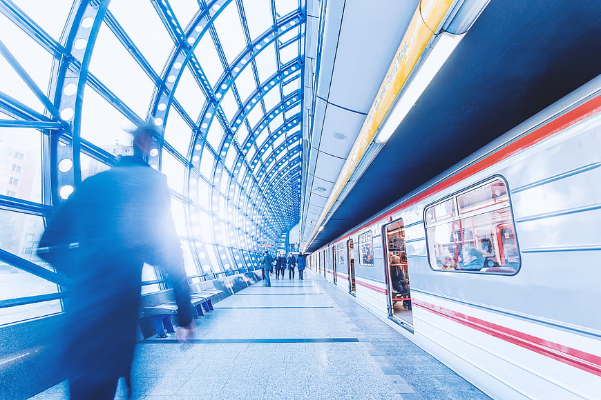 Motion blur of commuters at modern train station platform