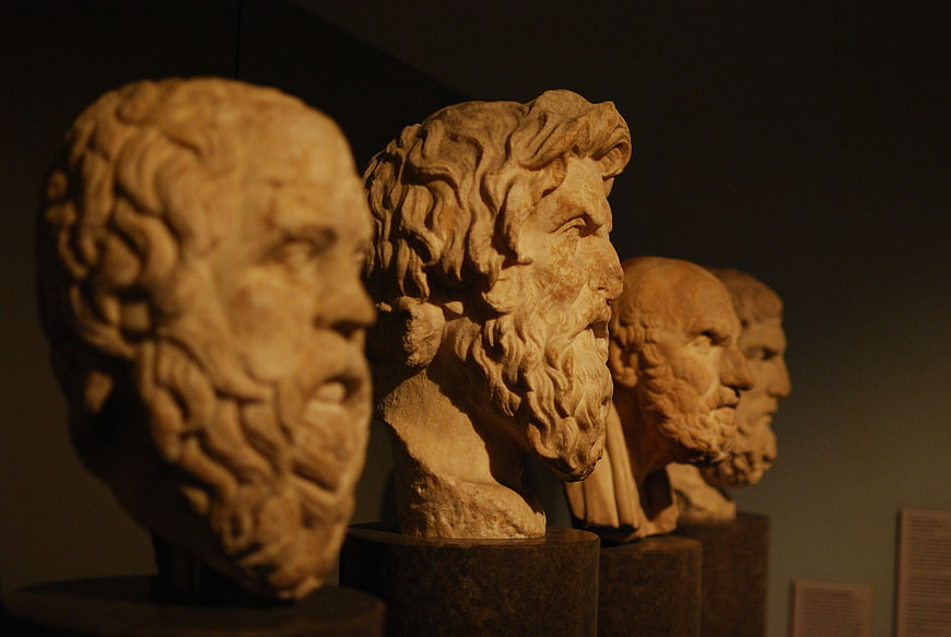 Ancient Greek marble philosopher busts in museum display