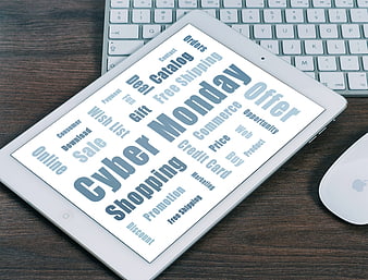 Cyber Monday word cloud on tablet screen with keyboard and mouse