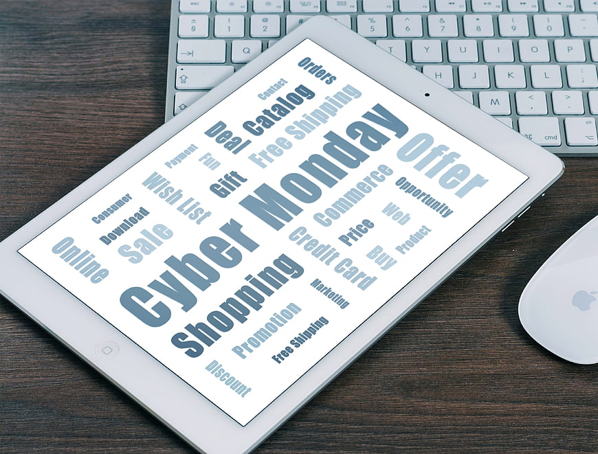 Cyber Monday word cloud on tablet screen with keyboard and mouse