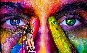 Woman painting colorful mural on ladder