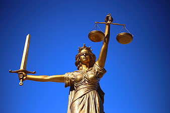 Golden Lady Justice Statue Against Blue Sky