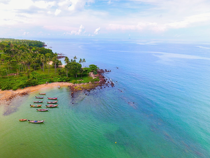 Aerial View of Tropical Beach with Longtail Boats
