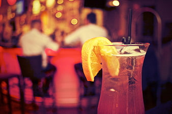 Refreshing cocktail with orange slice in a dimly lit bar