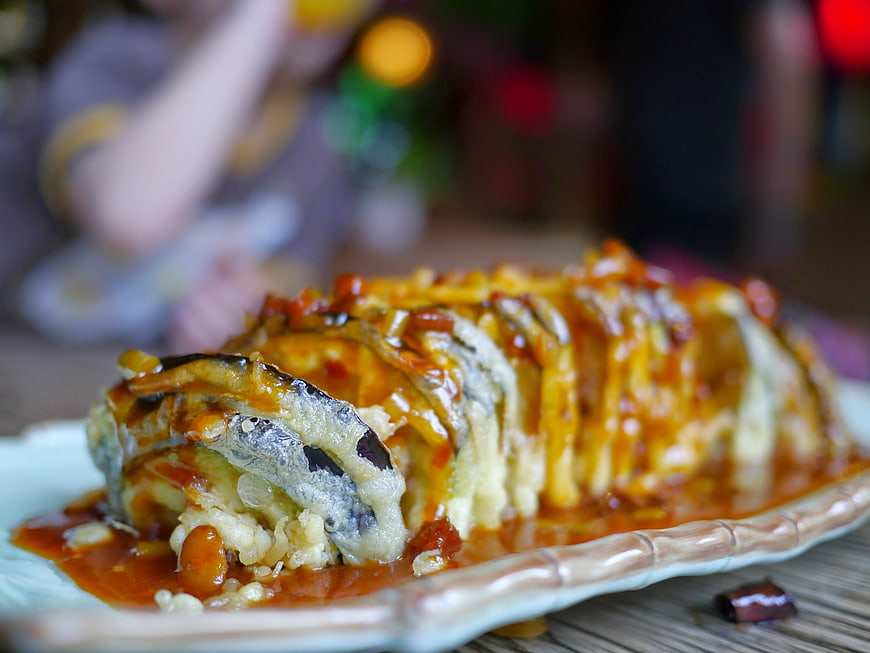 Close-up of fried eggplant dish with sauce on a plate