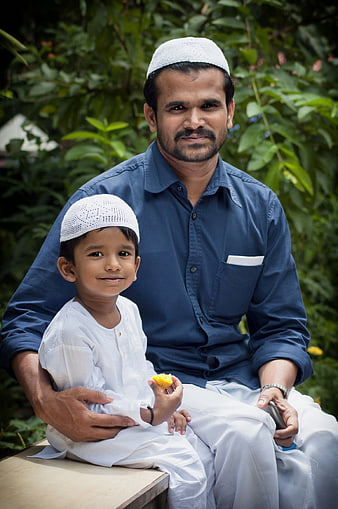 Muslim Father and Son Portrait Wearing White Caps