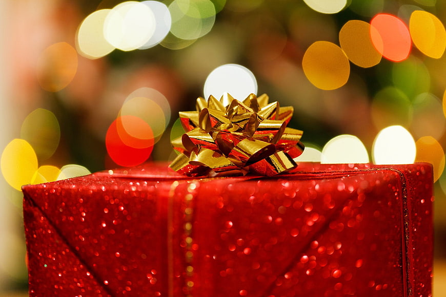 Red Glitter Christmas Gift Box with Gold Bow and Bokeh Lights