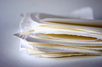 Close-up of stacked white paper sheets with soft lighting