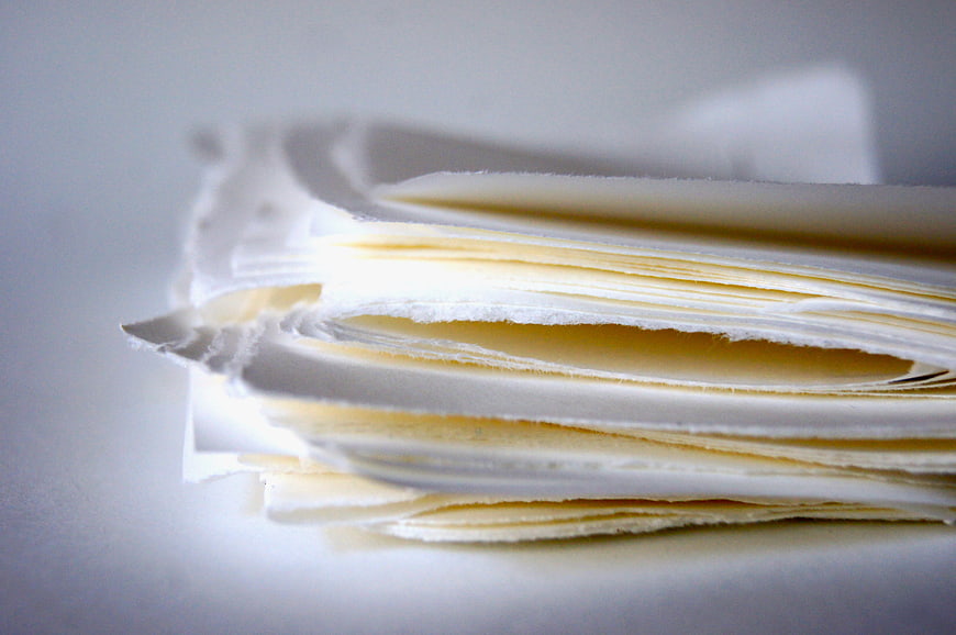 Close-up of stacked white paper sheets with soft lighting