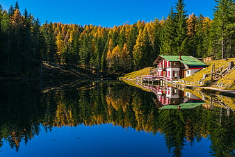 Alpine Cabin by Lake with Autumn Forest Reflection