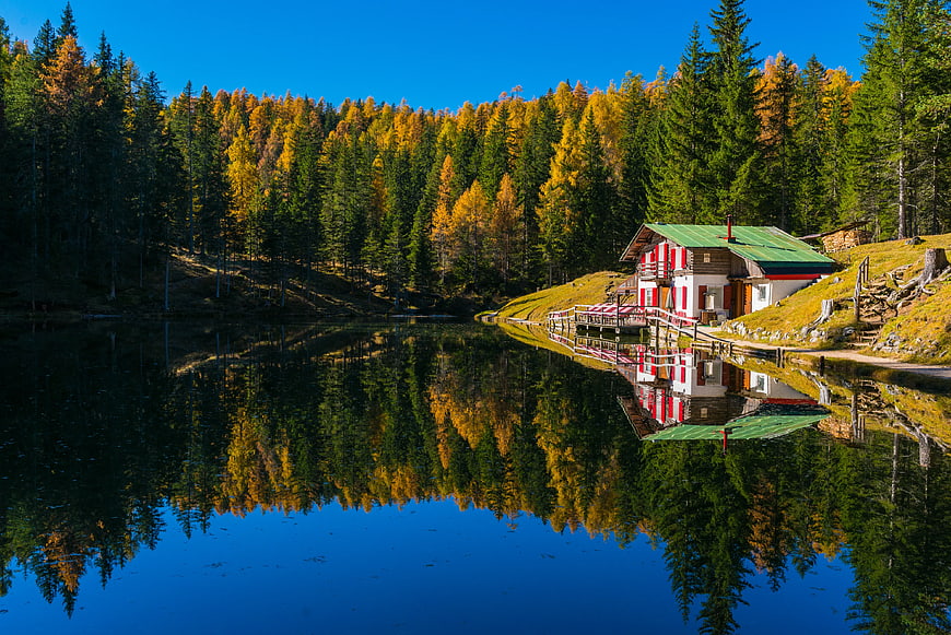 Alpine Cabin by Lake with Autumn Forest Reflection