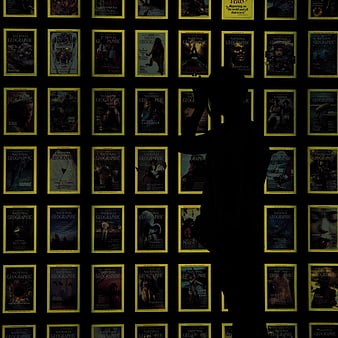 Silhouette of person standing in front of National Geographic magazine wall