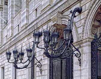 Ornate Iron Lanterns on Historic Stone Library Facade