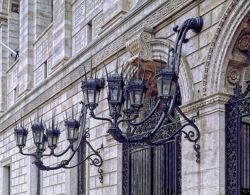 Ornate Iron Lanterns on Historic Stone Library Facade