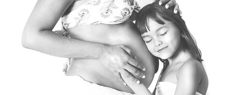 Pregnant Mother and Daughter Embracing in Black and White