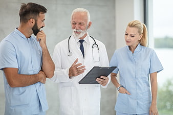 Medical Team Discussion in Hospital Corridor