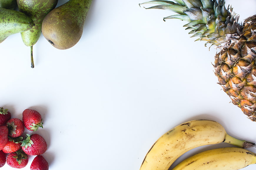 Top view of fresh tropical fruits on white background