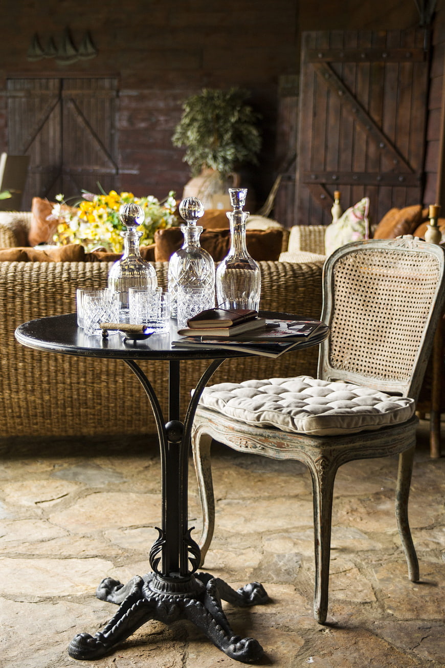 Rustic interior with vintage chair and crystal decanters