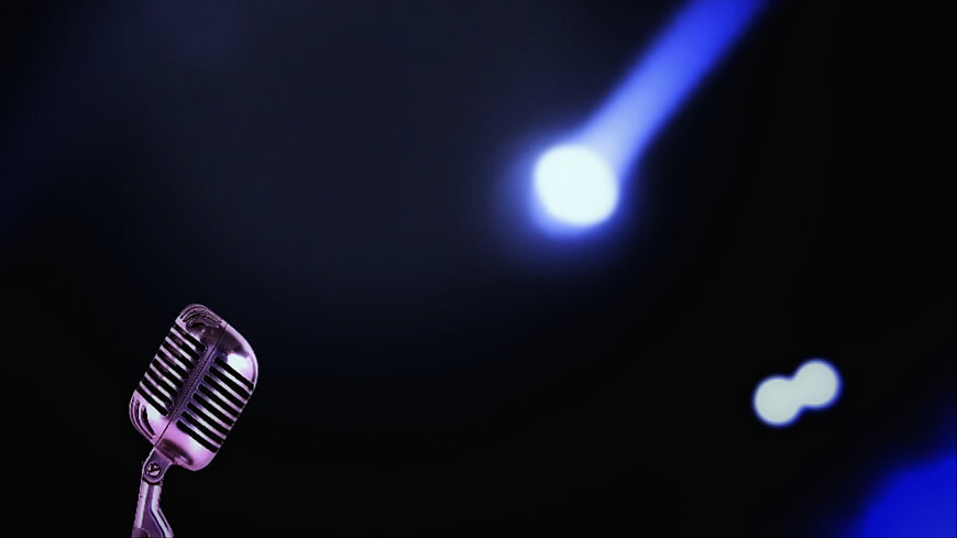 Vintage Microphone Under Blue Spotlight On Dark Stage