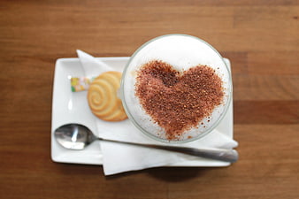 Top view cappuccino with heart foam art and cookie