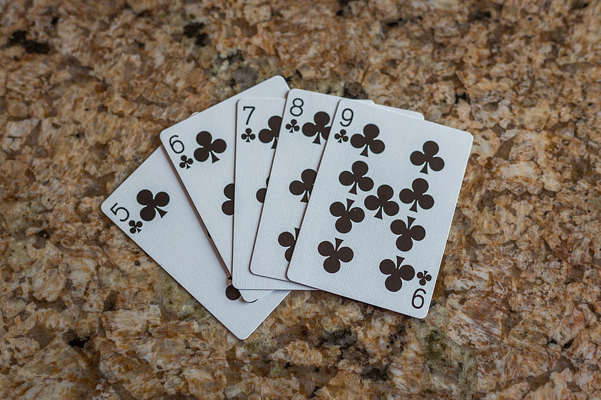 Straight Flush of Clubs on Granite Surface