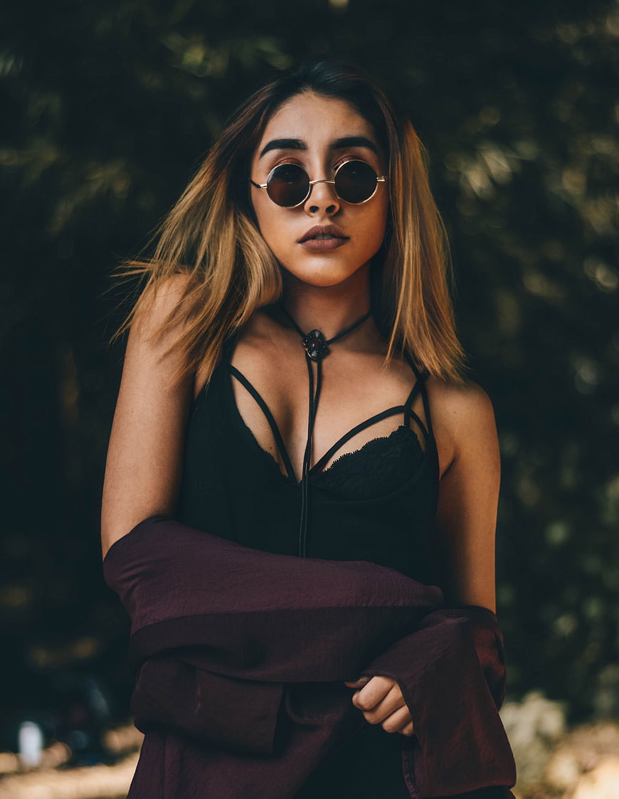 Stylish woman with round sunglasses and boho fashion outdoors