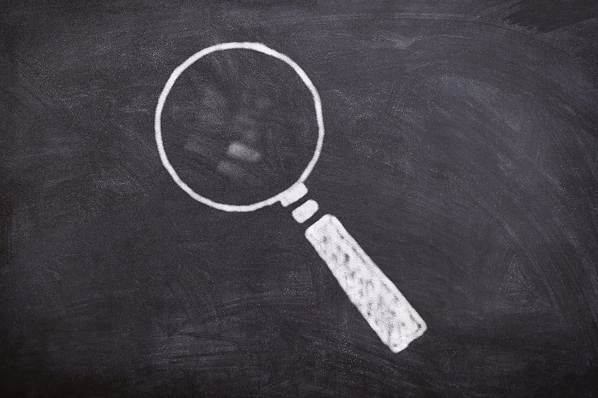 White Chalk Magnifying Glass Drawing On Dark Blackboard Surface
