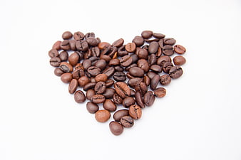 Coffee Beans Arranged In Heart Shape On White Background