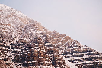 Snow-Covered Rocky Mountain Slope with Icy Textures