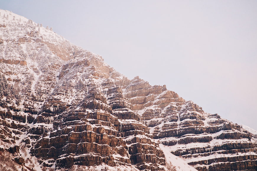 Snow-Covered Rocky Mountain Slope with Icy Textures