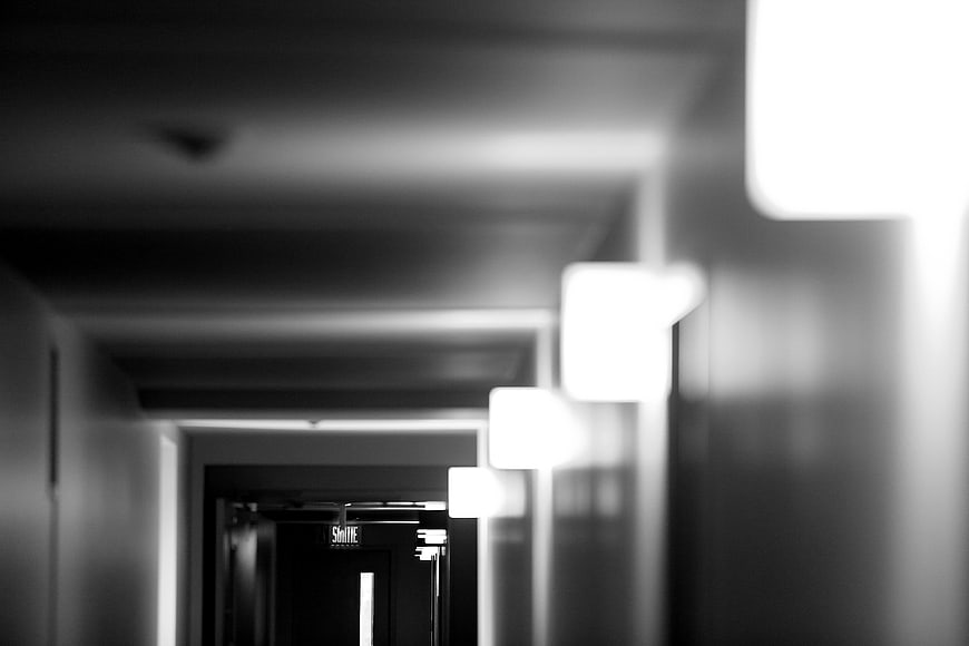 Abstract Black and White Blurred Hallway with Exit Sign