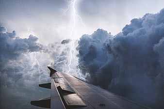 Airplane Wing Flying Through Dramatic Lightning Storm Clouds