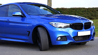 Blue BMW 4 Series Coupe on Asphalt Road