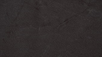 Dark textured background resembling black velvet or fabric