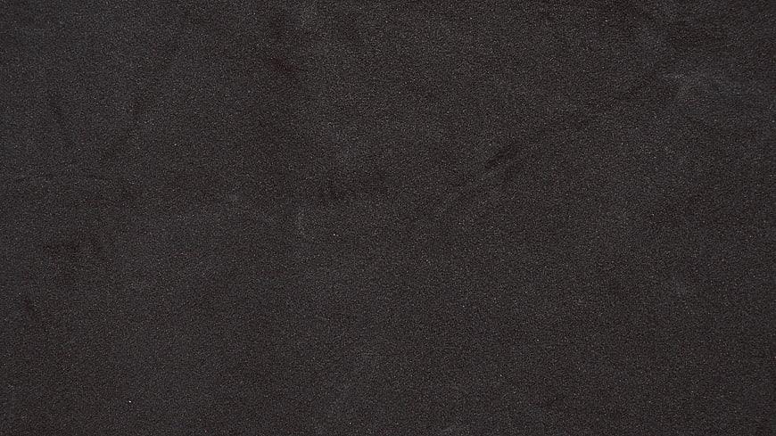 Dark textured background resembling black velvet or fabric