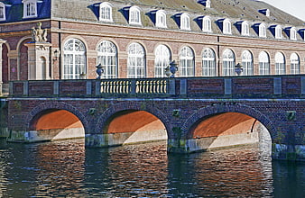 Historic brick palace bridge with arches over water