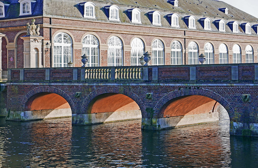 Historic brick palace bridge with arches over water