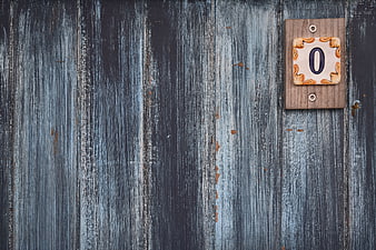 Rustic wooden door with ceramic number zero plaque