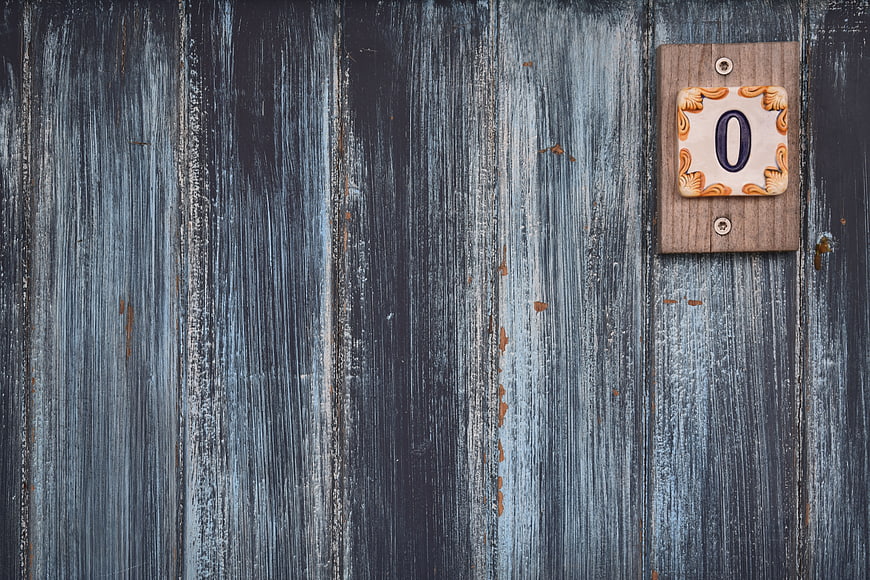 Rustic wooden door with ceramic number zero plaque