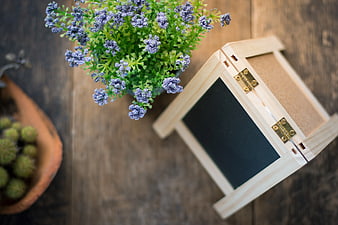 Wooden Sandwich Board with Purple Flowers on Rustic Table