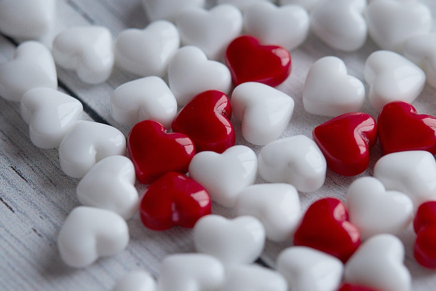 Red and White Heart Candies on Wooden Background