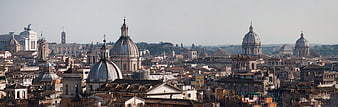 Panoramic view of Rome skyline with historic domes and architecture