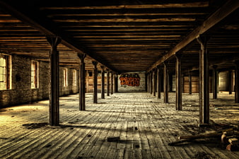 Abandoned Industrial Interior With Wooden Beams And Graffiti