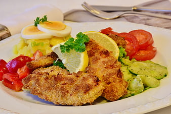 Homemade Breaded Chicken Schnitzel With Potato Salad And Fresh Vegetables