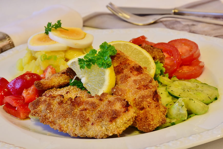 Homemade Breaded Chicken Schnitzel With Potato Salad And Fresh Vegetables