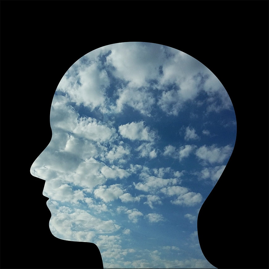 Human Head Silhouette Filled with Blue Sky and Clouds
