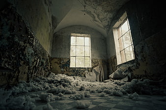 Abandoned Interior With Peeling Walls And Cotton Debris