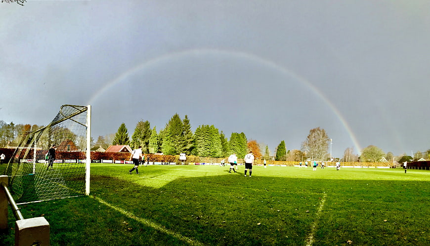 Rainbow arching over a football pitch during a match